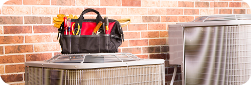 Tool bag sitting on top of AC unit